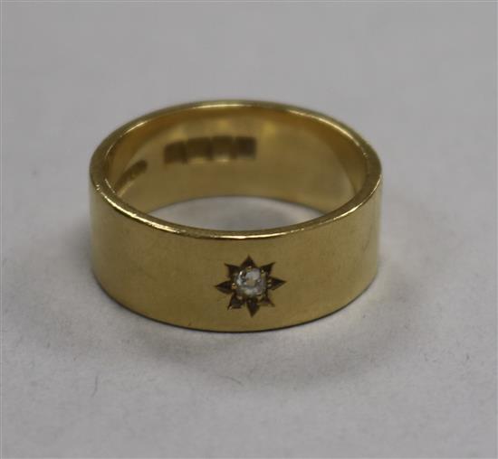An early 20th century 18ct gold and gypsy set diamond band, size T.